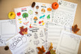 Load image into Gallery viewer, Educational worksheets and Fall themed word posters and activities on a beige surface.