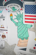 Load image into Gallery viewer, Coloring book page with Statue of Liberty, American flag, and bald eagle.