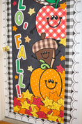 Load image into Gallery viewer, hello fall in primary colors walgreens classroom banner with a pumpkin, acorn, acorn, pumpkin, football and leaf on it with gingham details on a black background.
