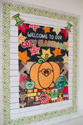 Load image into Gallery viewer, welcome to our cozy classroom tapestry with a pumpkin with glasses and leaves and fall inspired school supplies.