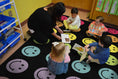 Load image into Gallery viewer, Rainbow Smileys on Black Sit Spots Classroom Rug by Schoolgirl Style