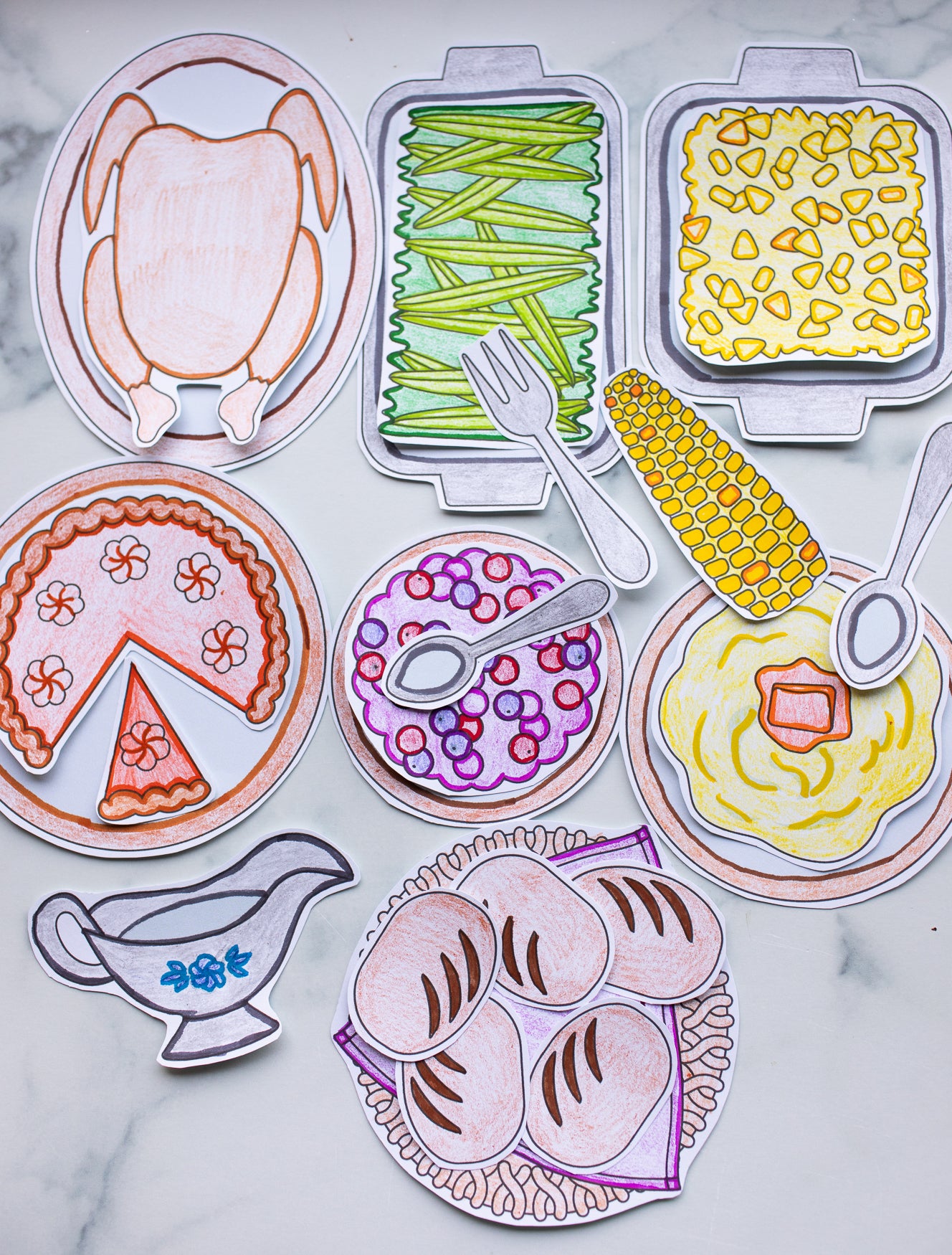 Colorful illustrations of food items on a marble surface.  My thanksgiving dinner craft.