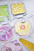 Load image into Gallery viewer, Colorful paper cutouts of food items including pasta, corn, and bread on a white background.
