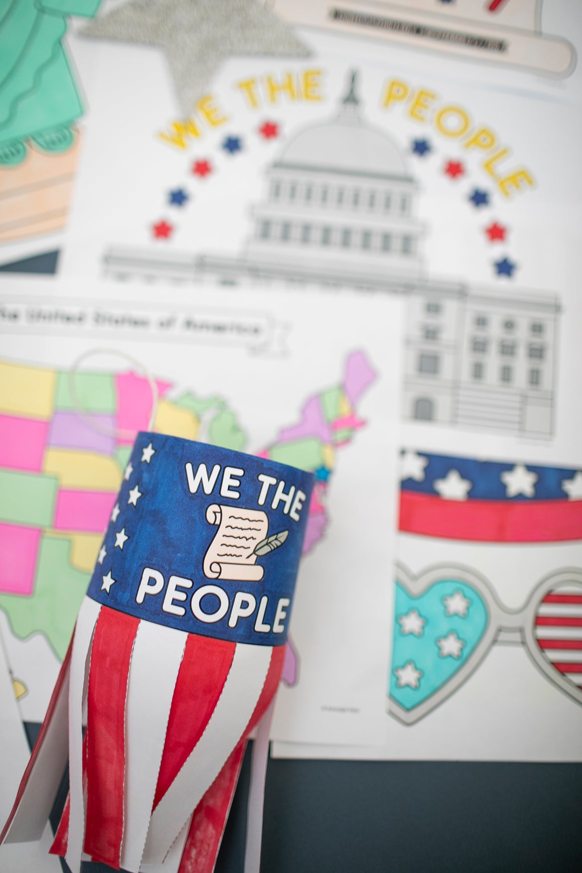Decorative windsock with 'We the People' text and American flag design on a colorful background.