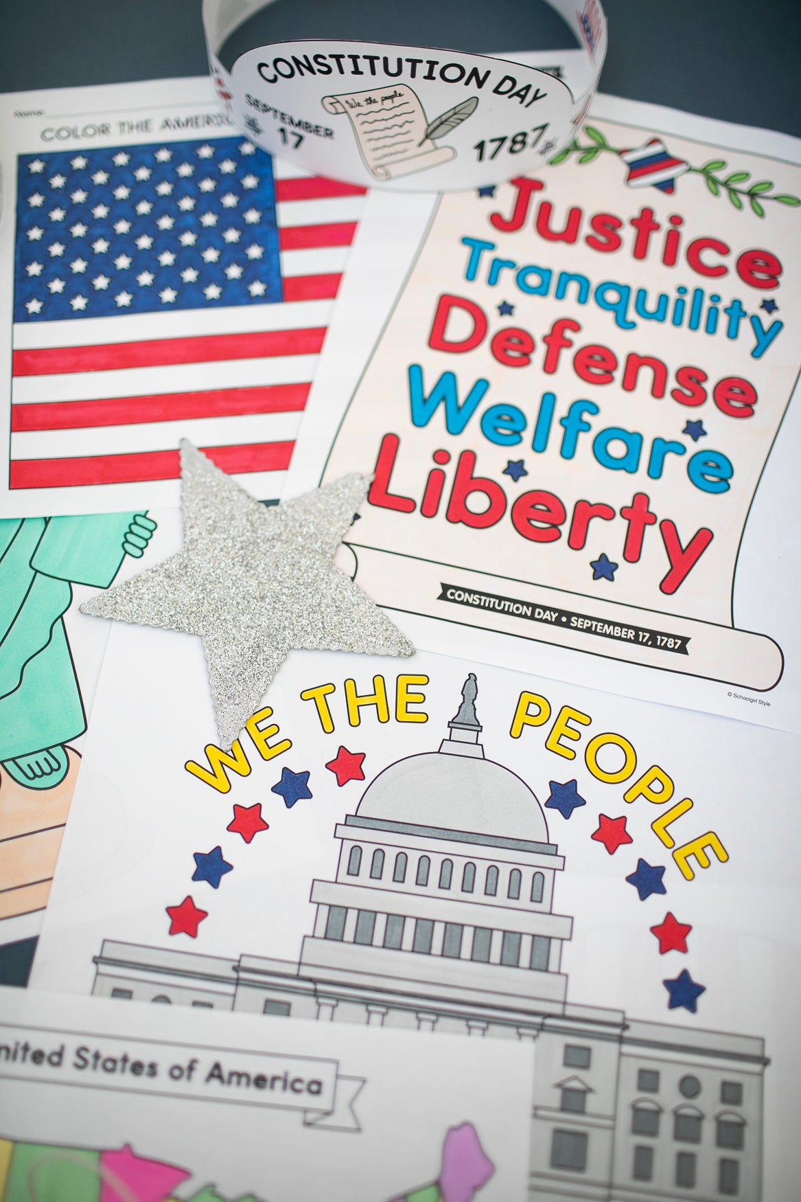 Educational materials about the Constitution on a table with an American flag and star.