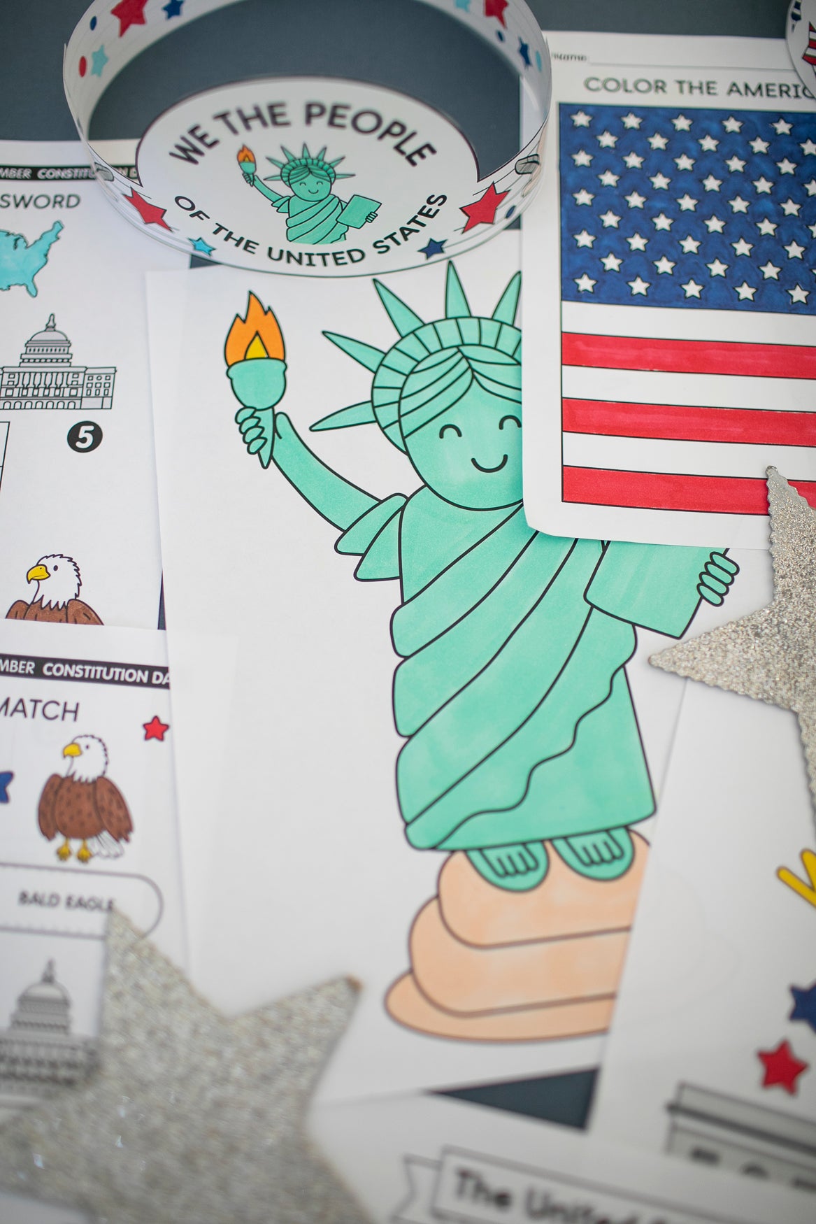 Coloring book page with Statue of Liberty, American flag, and bald eagle.