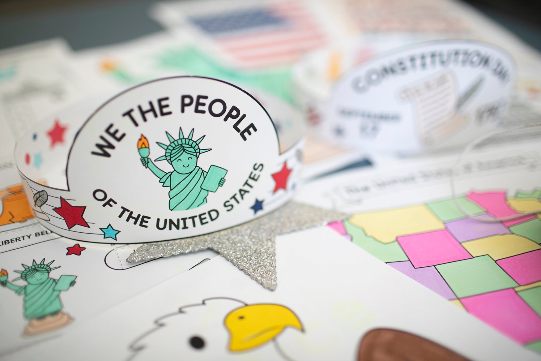 Children's book with illustrations of the Statue of Liberty and an eagle, featuring text 'We the People of the United States'.
