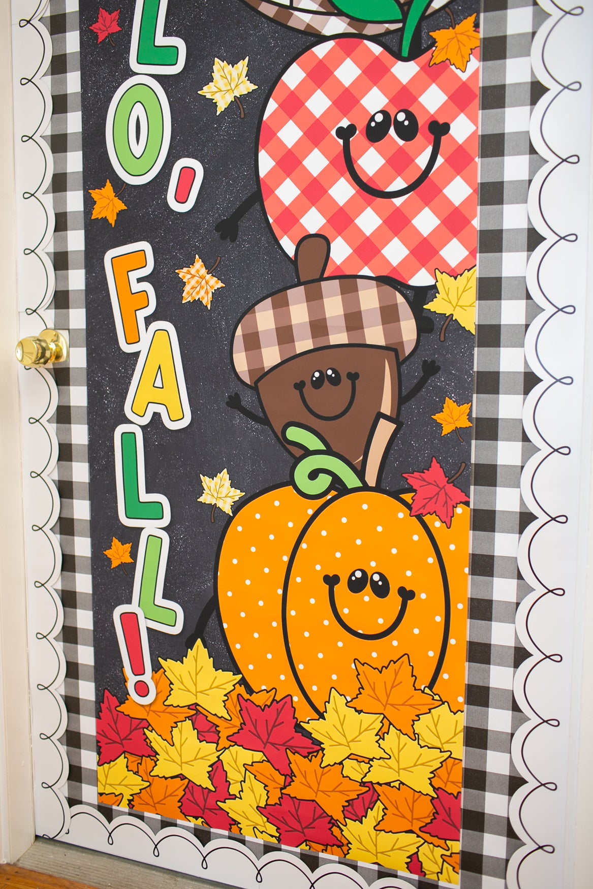 hello fall in primary colors walgreens classroom banner with a pumpkin, acorn, acorn, pumpkin, football and leaf on it with gingham details on a black background. 