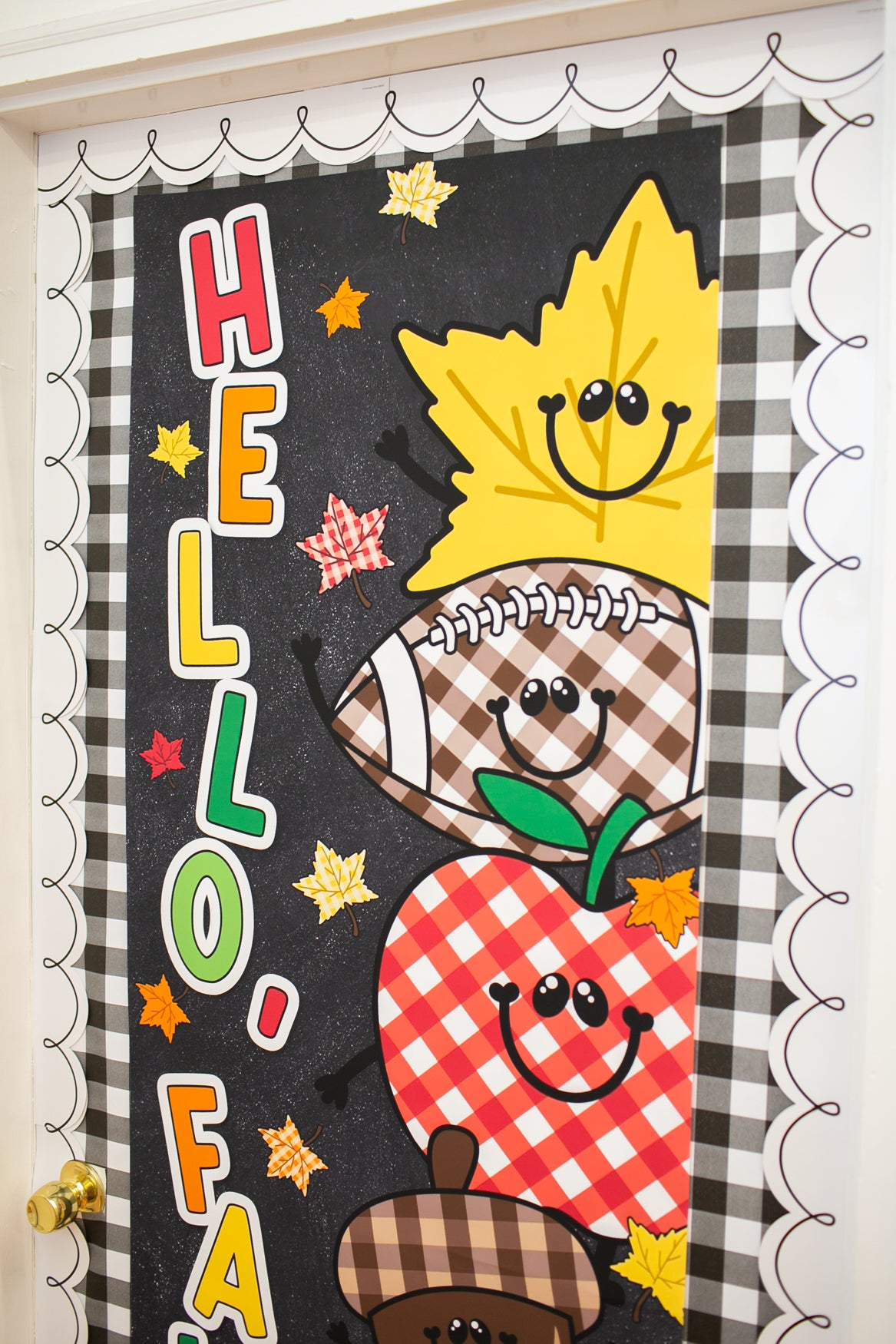 hello fall in primary colors walgreens classroom banner with a pumpkin, acorn, acorn, pumpkin, football and leaf on it with gingham details on a black background. 