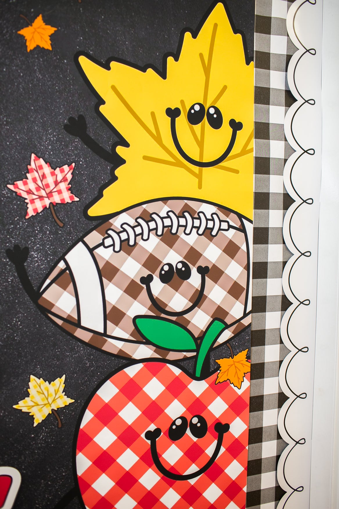hello fall in primary colors walgreens classroom banner with a pumpkin, acorn, acorn, pumpkin, football and leaf on it with gingham details on a black background. 