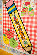 Load image into Gallery viewer, A large decorative pencil-shaped sign reading “SEPTEMBER” is displayed on a red-and-white checkered classroom-style wall with apple illustrations and a small sign that says “APPLE-SOLITELY AWESOME!”.
