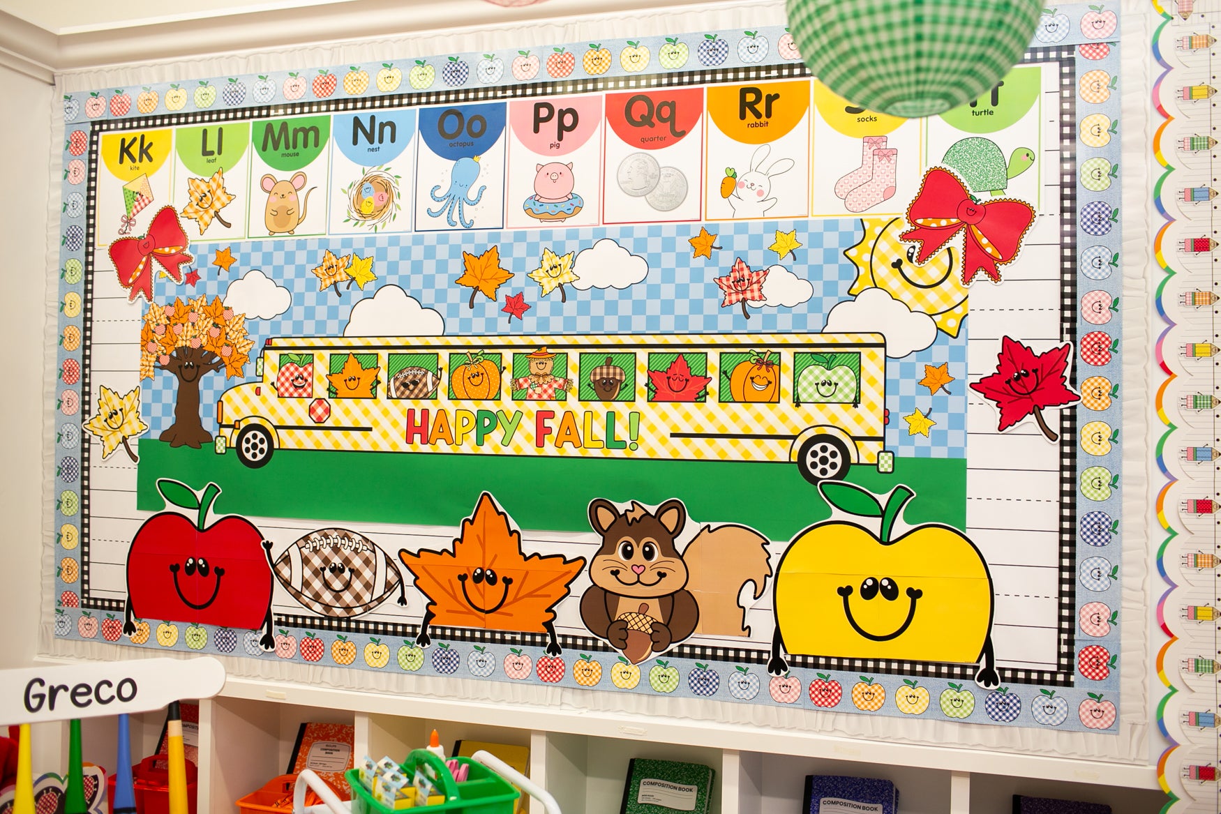 horizontal happy fall classroom banner that you get printed at Walgreens and the bus has happy fall icons peeking out of the window such as a leaf, scarecrow, acorn, and gingham apples.  