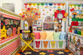 Load image into Gallery viewer, A decorated children's classroom corner with autumn-themed wall displays, colorful pillows, a tree cutout, a clock, and a bench with fall illustrations. No person or animal is present, and the scene appears to be a styled interior setup rather than a single isolated retail product.
