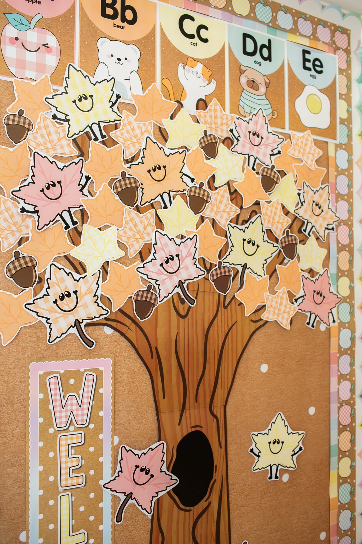 classroom tree decor with pastel leaves and acorns
