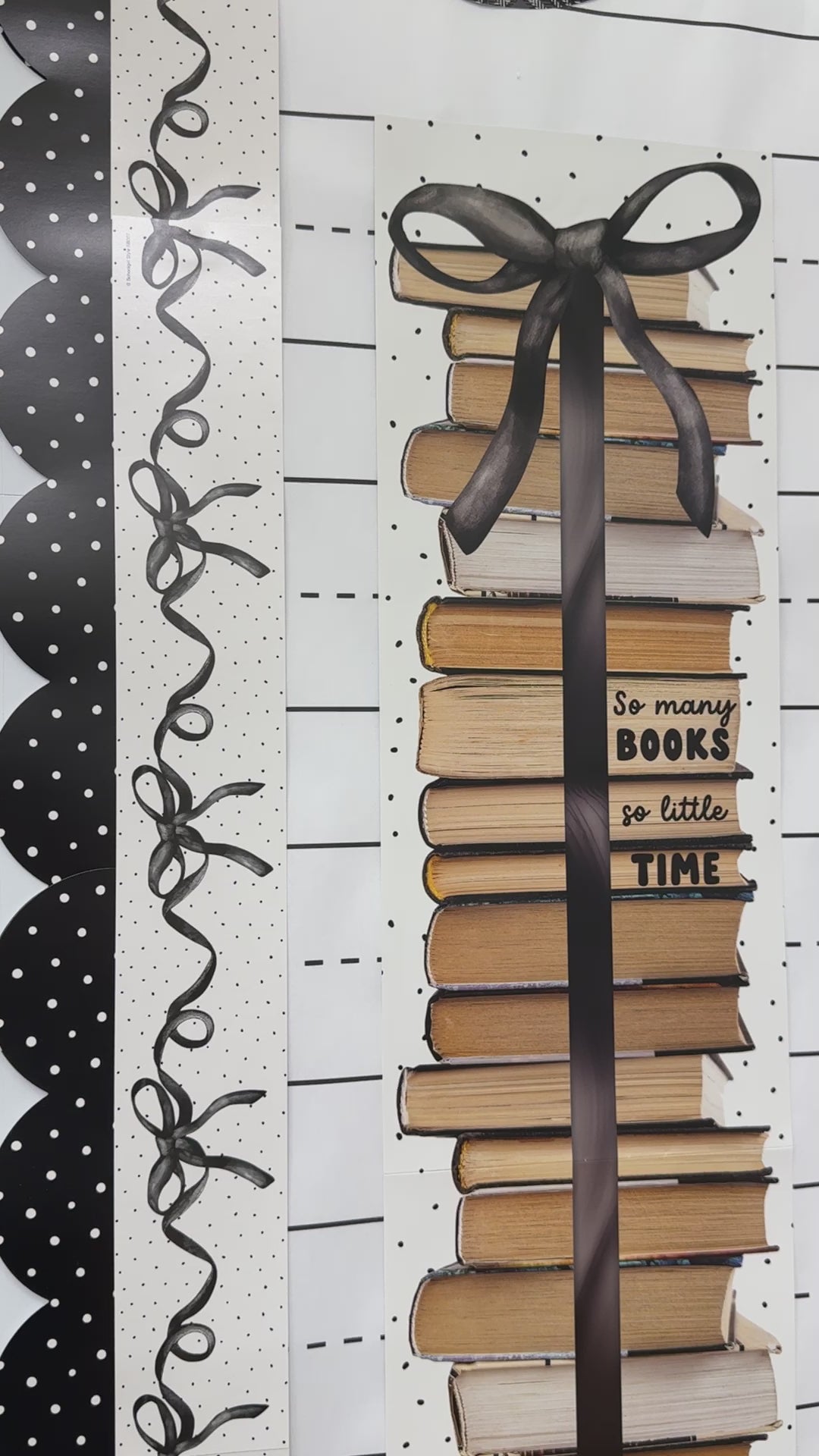 Tall book stack cutout with the text so many books so little time 