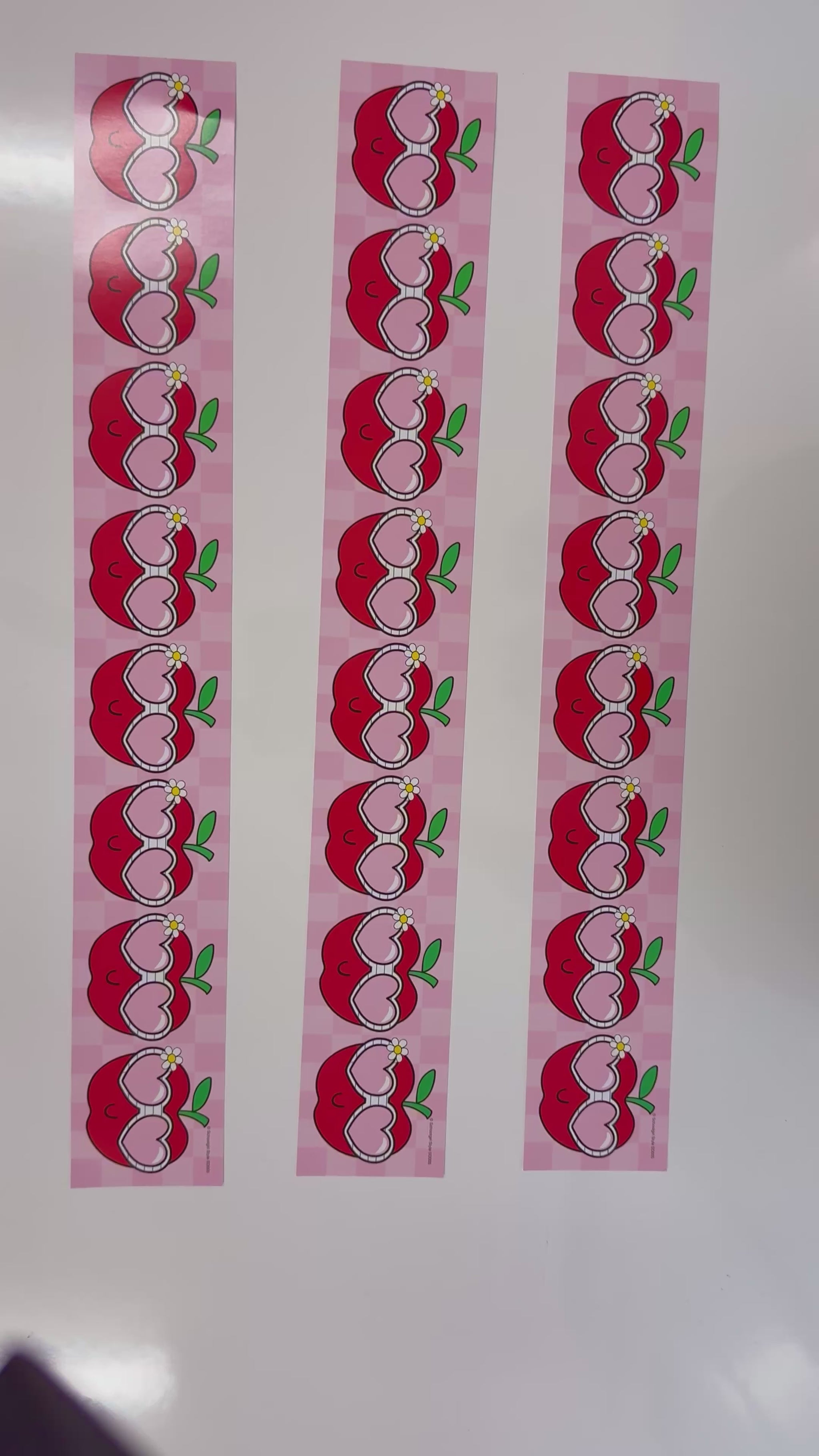 Pink and red apples with sunglasses border 