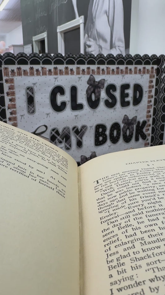 I closed my book to be here black cutouts with large stack of books 