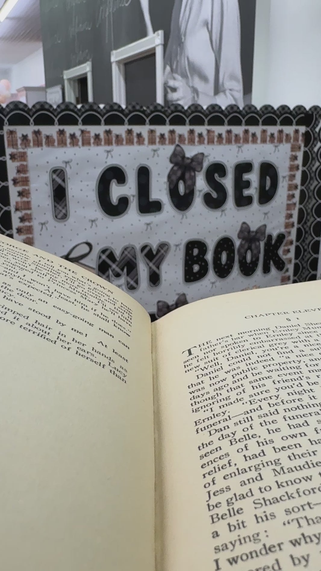 I closed my book to be here black cutouts with large stack of books 