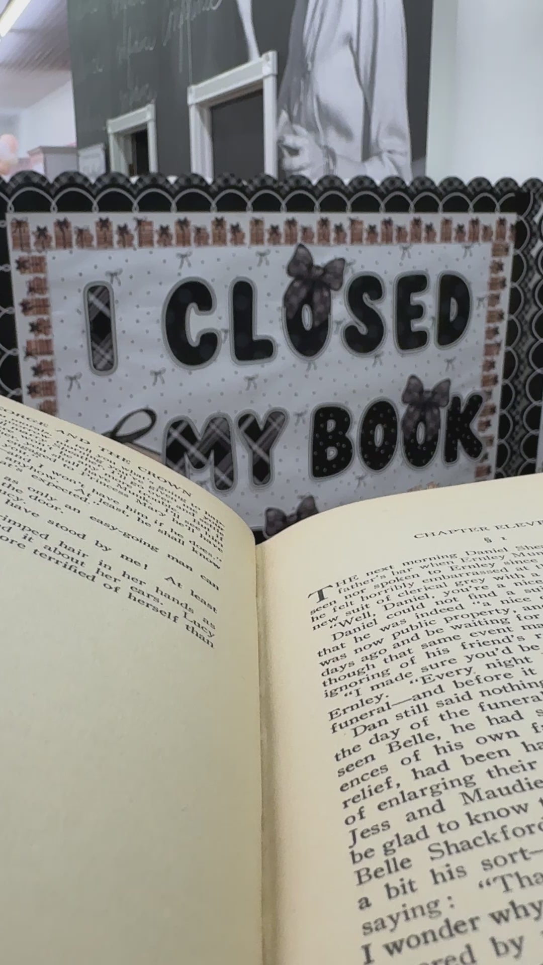 I closed my book to be here black cutouts with large stack of books 